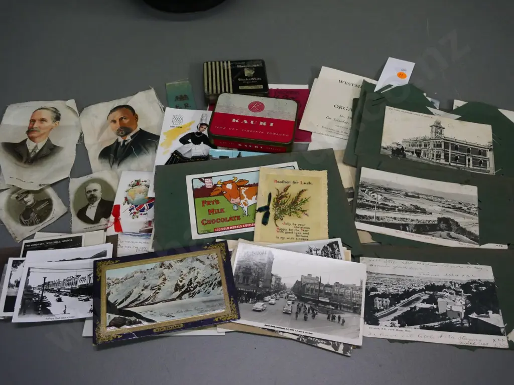 collection of photos, tins, greeting cards, portraits printed on fabric, early NZ postcards on torn album sheets etc. Image 1++
