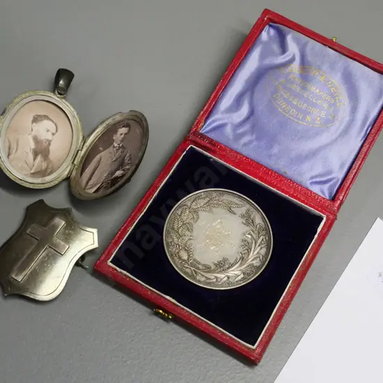 cased 1874 Otago Girls' High SchoolDux medal - M.S. Maitland, unmarked locket w/2 photos & a cross & shield brooch