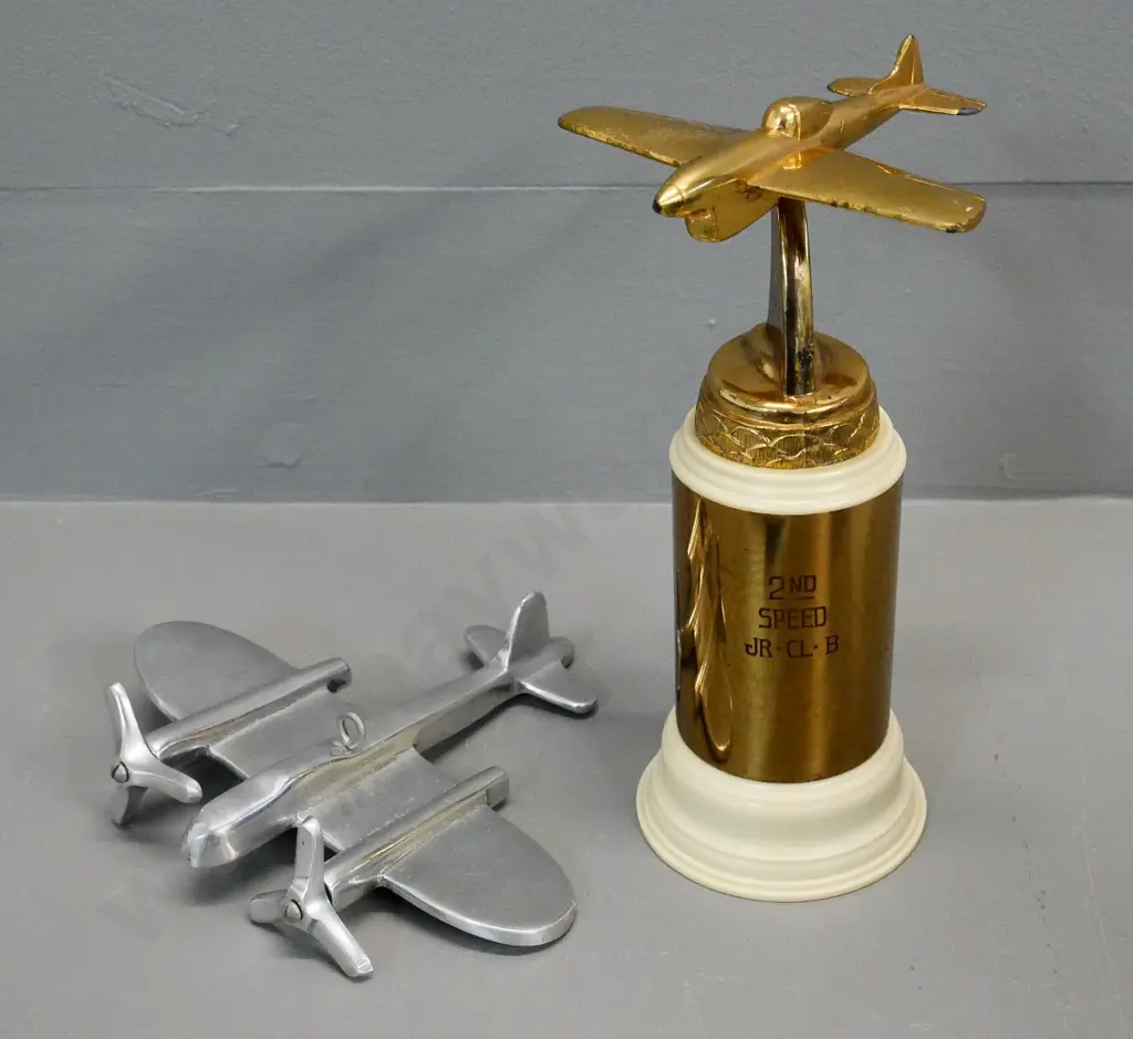 gold-tone metal and plastic aeroplane trophy H-190 engraved "Jr. Cl. B. - 2nd in Speed Section" and a chrome aeroplane Image 1++
