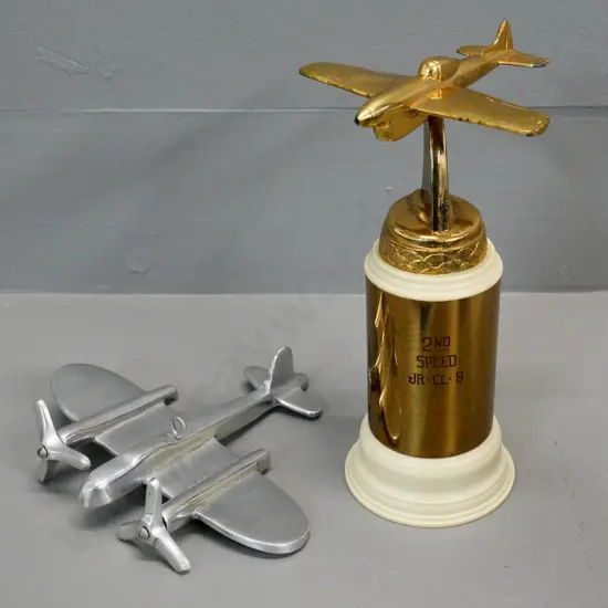 gold-tone metal and plastic aeroplane trophy H-190 engraved "Jr. Cl. B. - 2nd in Speed Section" and a chrome aeroplane