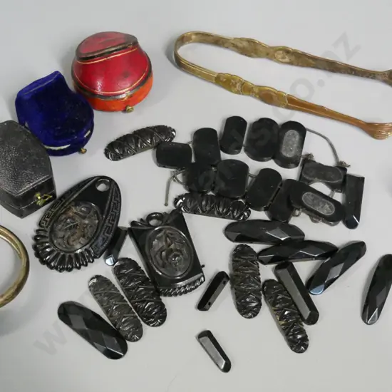 jet or faux jet carved necklace pieces, vintage ring cases, asian style metal sugar tongs and one other, bracelet, etc.