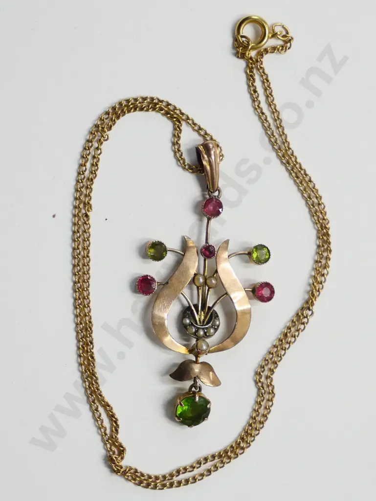 pendant marked 9 CT with red and green stones and seed pearls Image 1++
