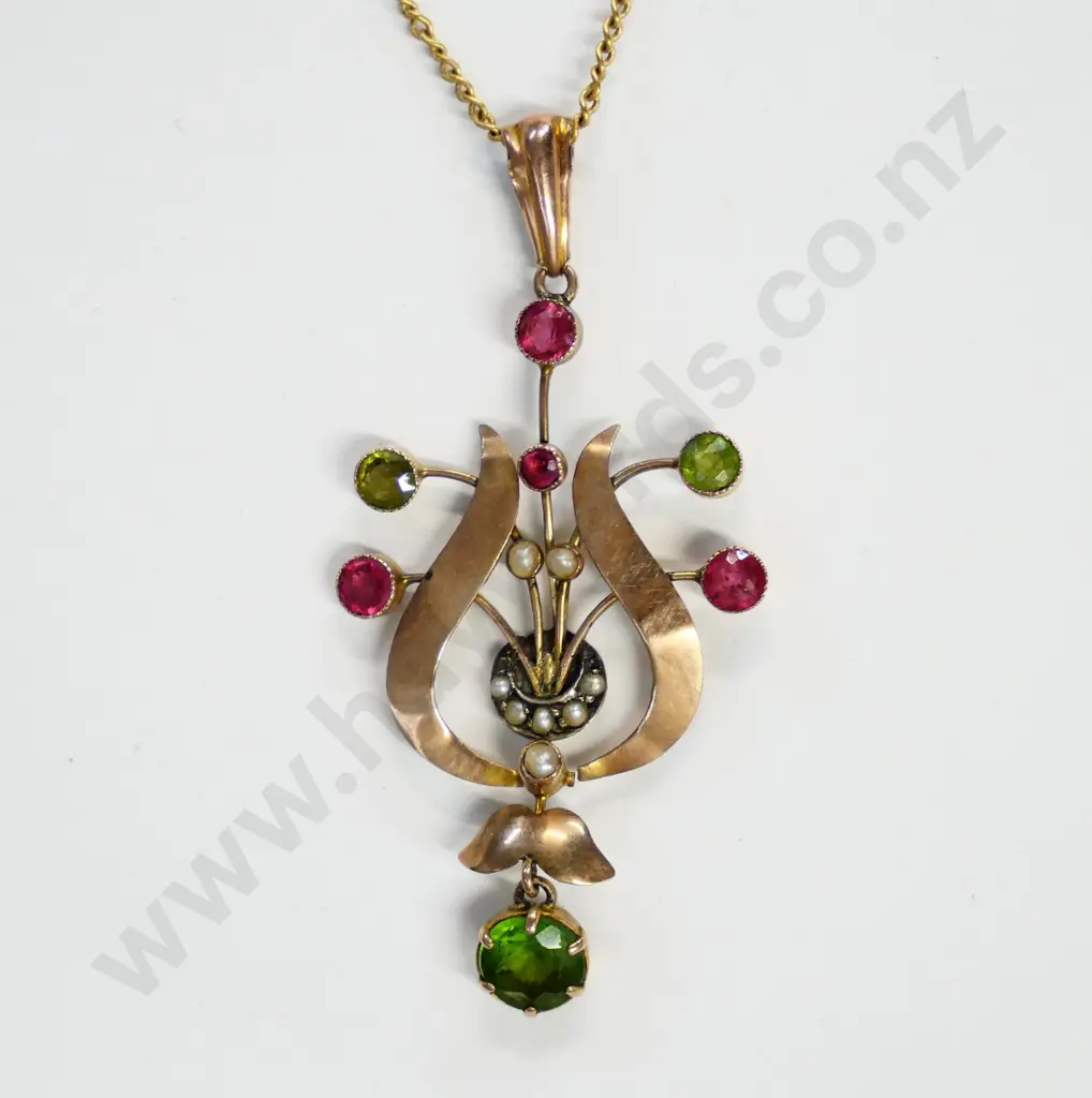 pendant marked 9 CT with red and green stones and seed pearls Image 1++