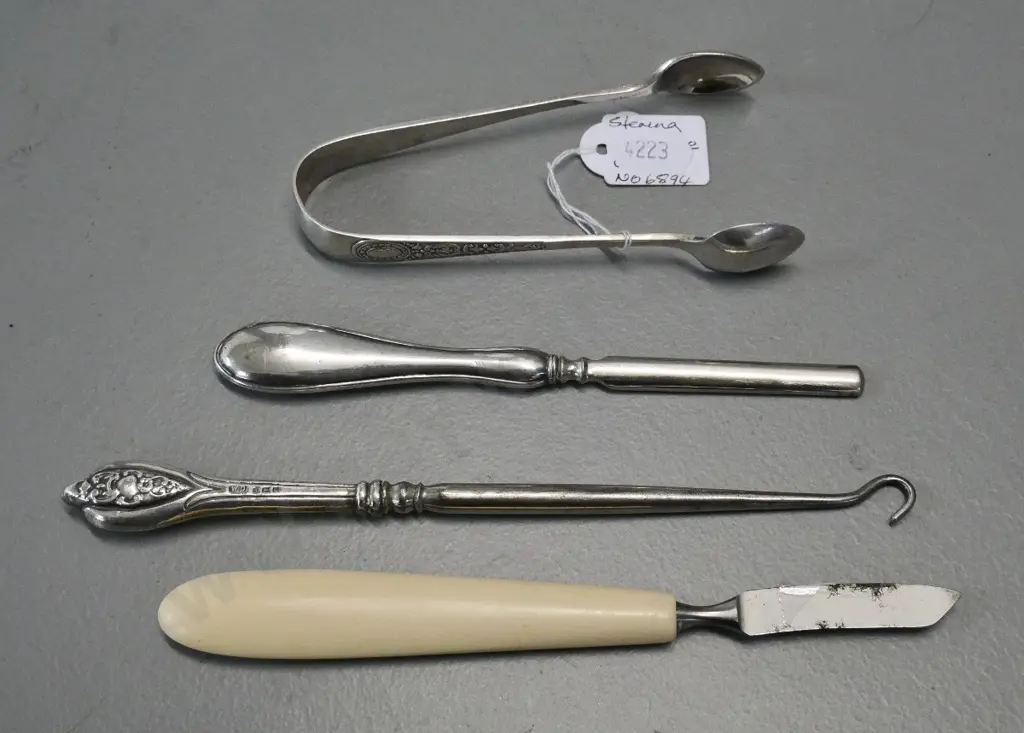3 pieces sterling silver - button hook, nail implement and sugar tongs - and a bone handled manicure item Image 1++