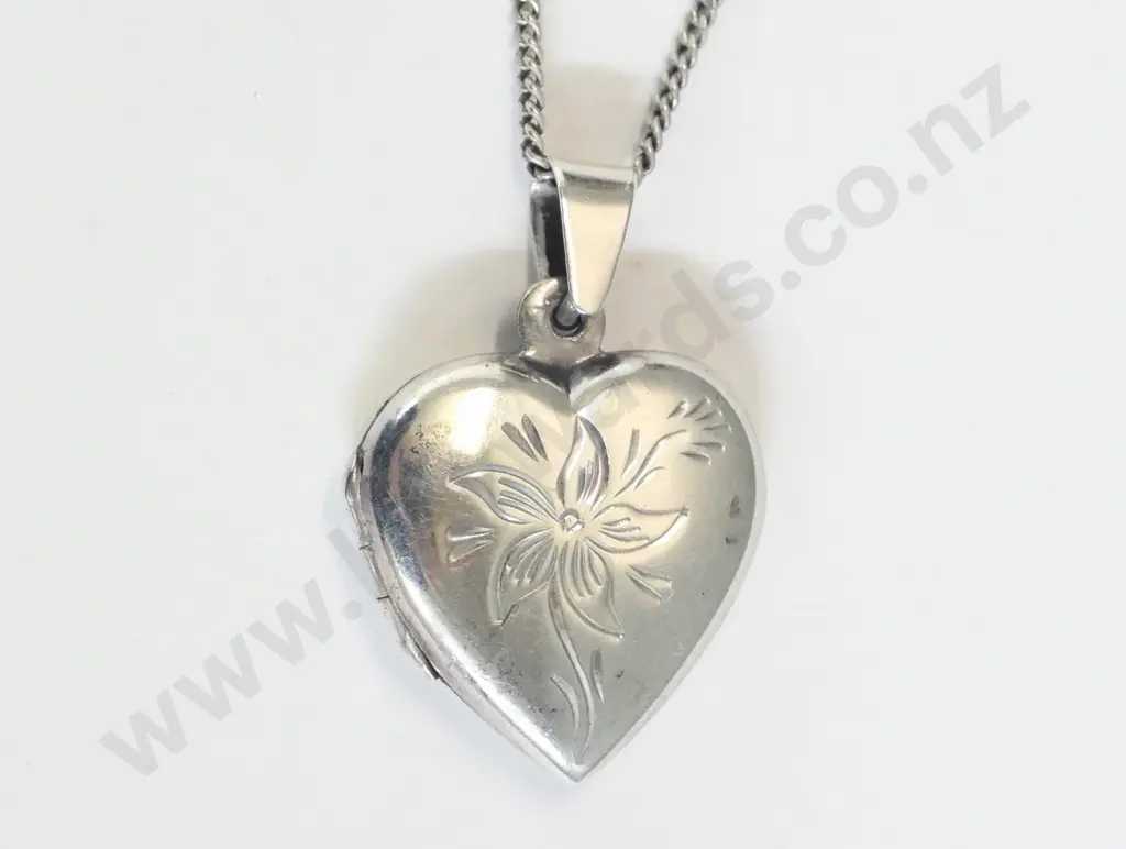 silver heart shaped locket has flower engraving on front stamped 925 Image 1++