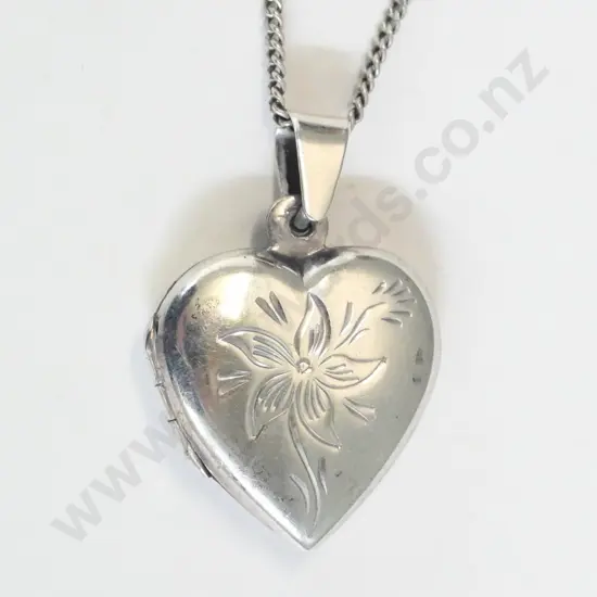 silver heart shaped locket has flower engraving on front stamped 925