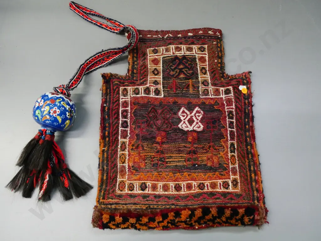 hand-woven middle-eastern bag with narrow opening and a ceramic bauble on woven strap with horsehair tassels Image 1++