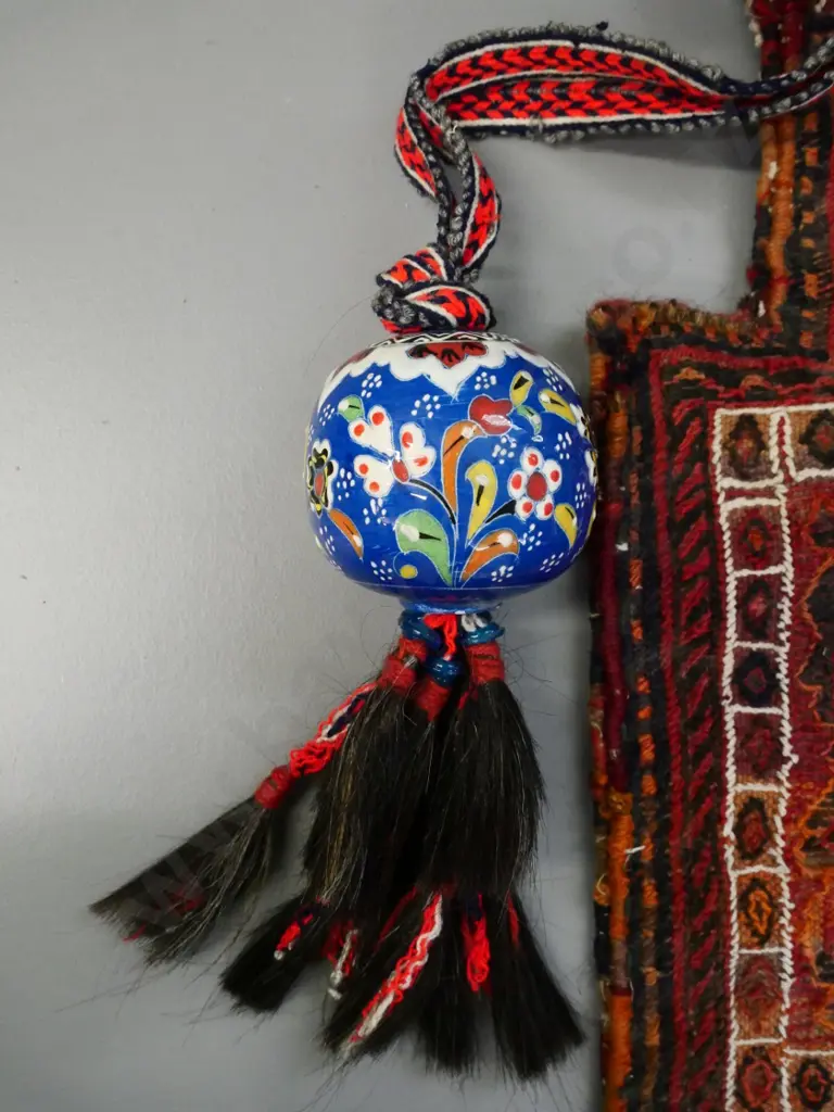 hand-woven middle-eastern bag with narrow opening and a ceramic bauble on woven strap with horsehair tassels Image 1++