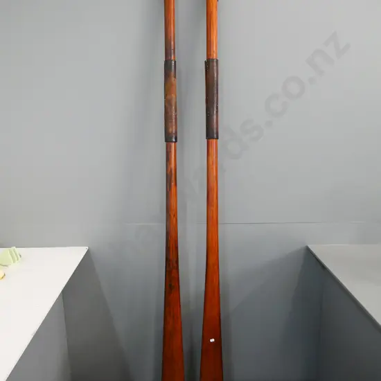 vintage pair of rowing oars with heavy leather sleeves L-1970