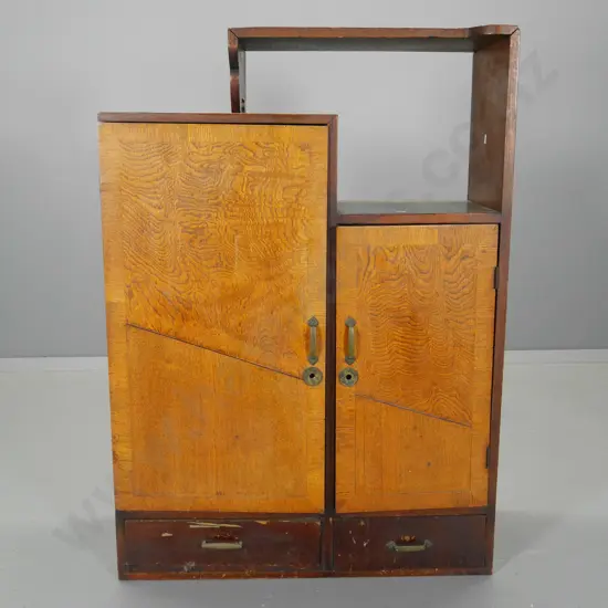 vintage oak cabinet w/open shelf, 2 drawer, 2 doors w/banded edges, brass handles. 1 door slightly warped H990 W700 D270