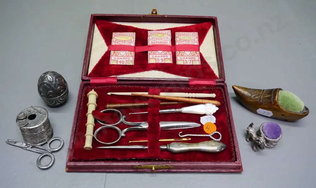 sewing/manicure case with sterling silver handled button hook, thread, pin cushions, bone and wood items, etc. Image 1++