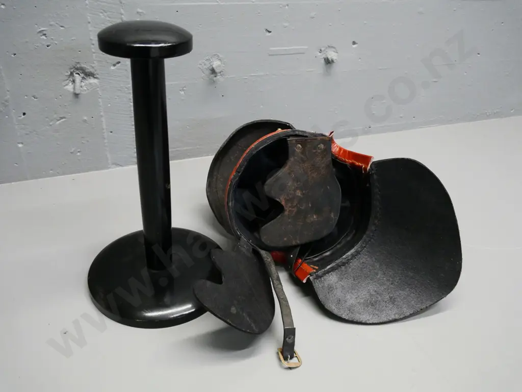 reproduction Roman leather helmet with brass studs and a wooden stand Image 1++