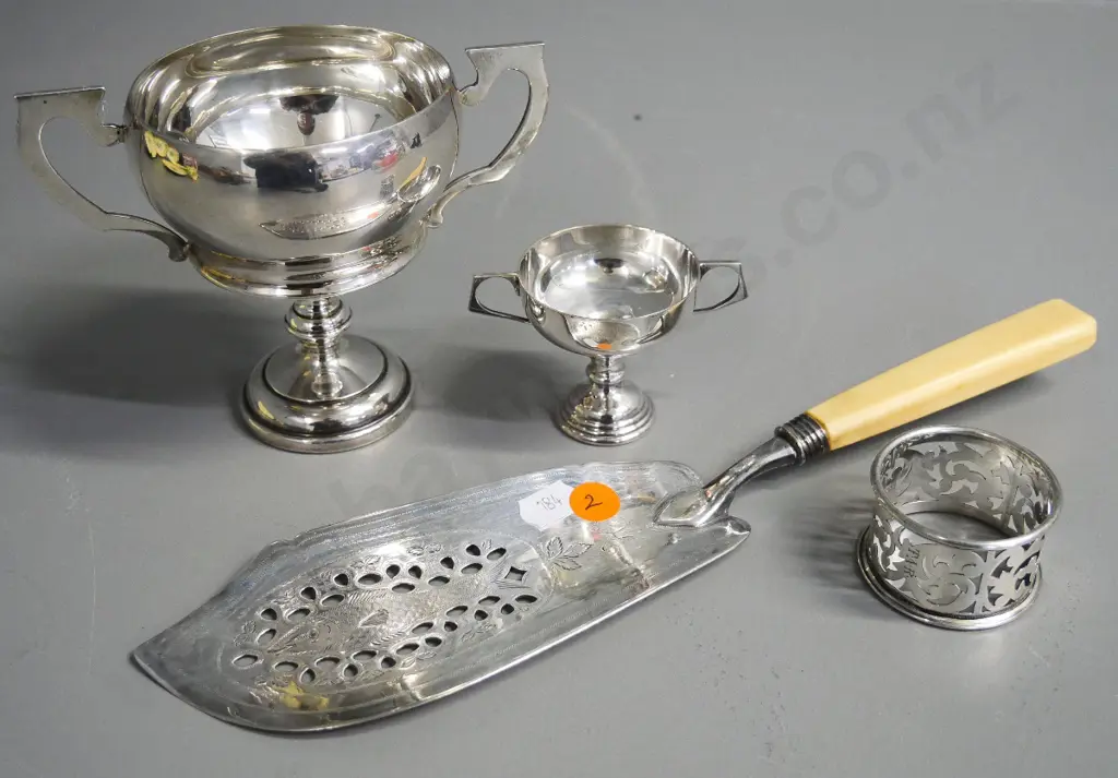 sterling silver bone-handled serving slice, napkin ring and trophy cup H-110, and an unmarked small cup Image 1++