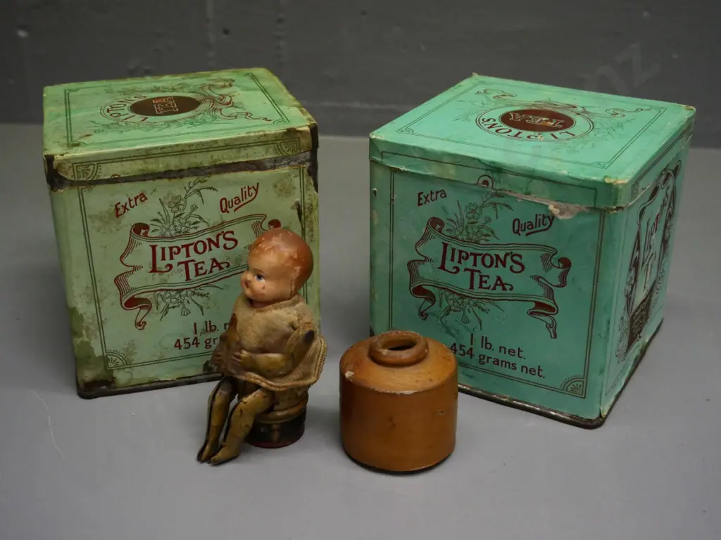 small German mechanical toy with celluloid head, no key, 2 Lipton's tea tins, 1 has contents, stoneware ink bottle Image 1++