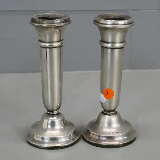 pair of small sterling silver candlesticks - one has damage to rim H-160