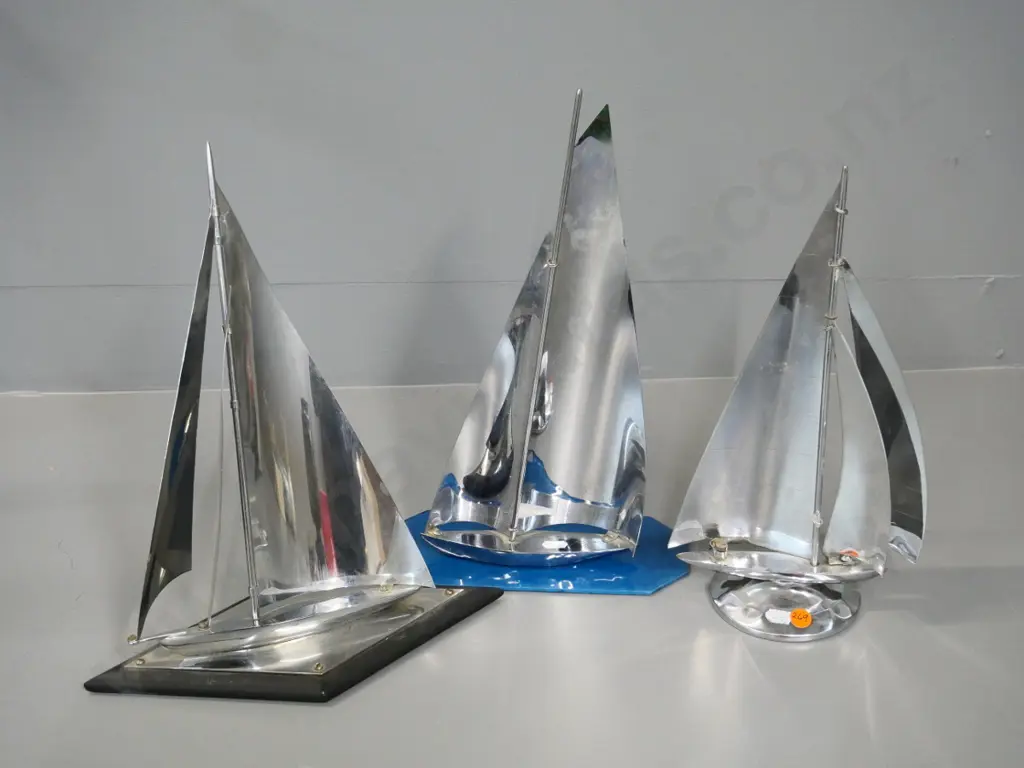 3 chrome yachts - one on glass base H-360, one on wooden base, slight discolouration or pitting, one has minor repair Image 1++