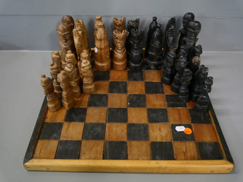 hand-carved wood chess set with board - tribal style figures, one pawn has damage - board 340x340 Image 1++