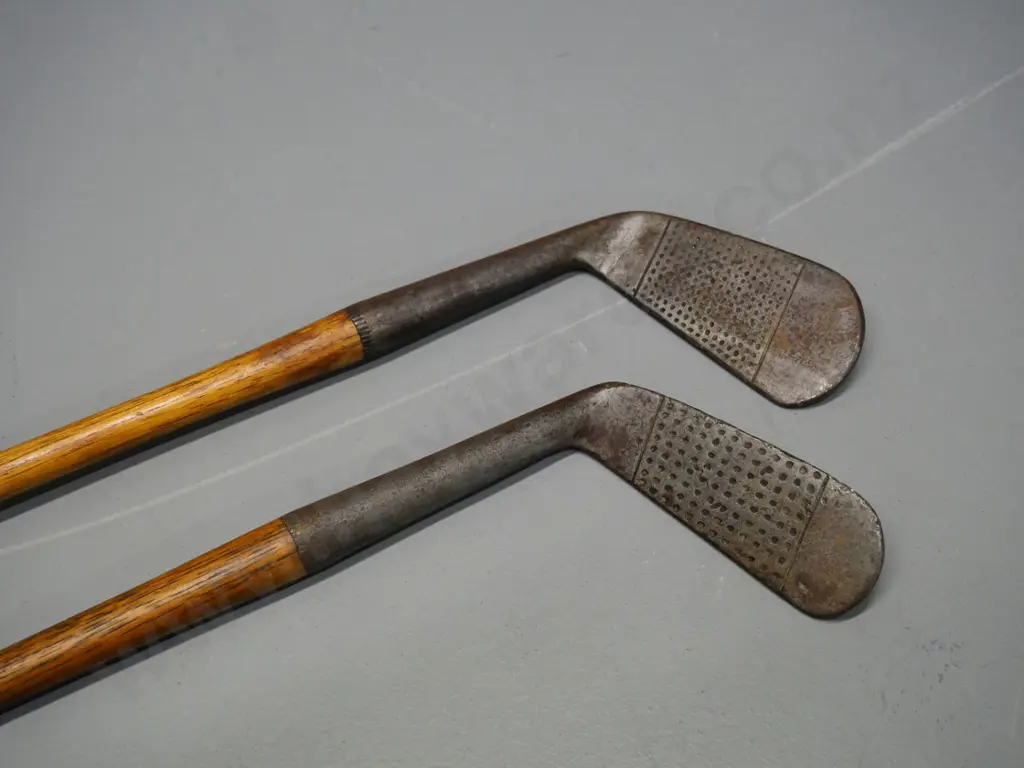 2 vintage golf clubs with wooden stems and leather grips Image 1++
