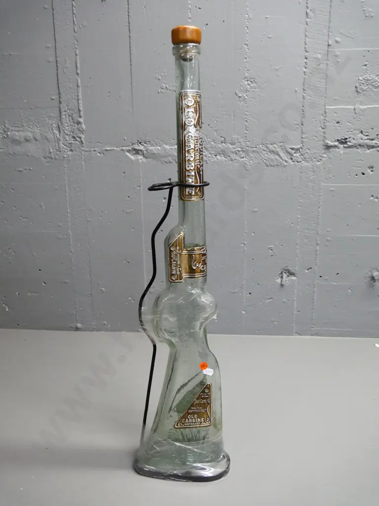 tall rifle-shaped Old Carbine tequila bottle (empty) in metal stand - some wear to metal labels. H-630 Image 1++
