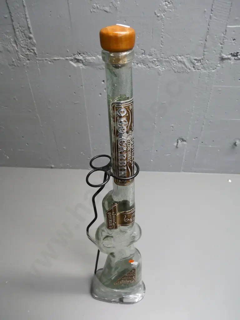 tall rifle-shaped Old Carbine tequila bottle (empty) in metal stand - some wear to metal labels. H-630 Image 1++