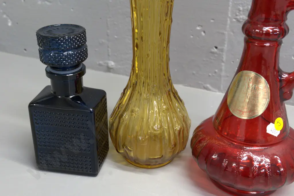 retro coloured glass items - red Jim Beam stoppered decanter H330, small dark blue stoppered bottle, and an amber vase Image 1++