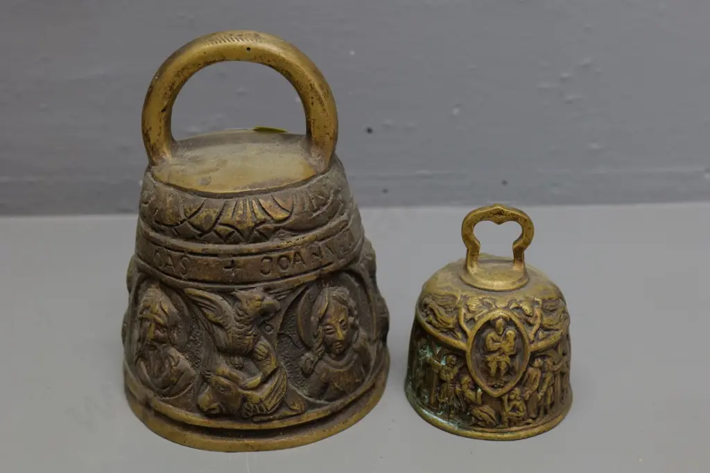 2 ornate heavy cast brass bells with medieval motifs - larger is H-150 D-150 Image 1++