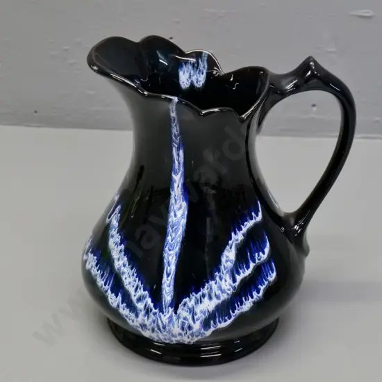 Blue Mountain pottery jug - black with navy blue and white pattern H-200 W-170 at handle - small chip to base
