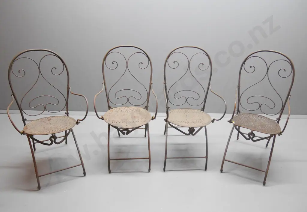 4 wrought iron French style collapsible cafe chairs w/stamped seats, one w/damage to arm bracket H1030 W520 D520 Image 1++