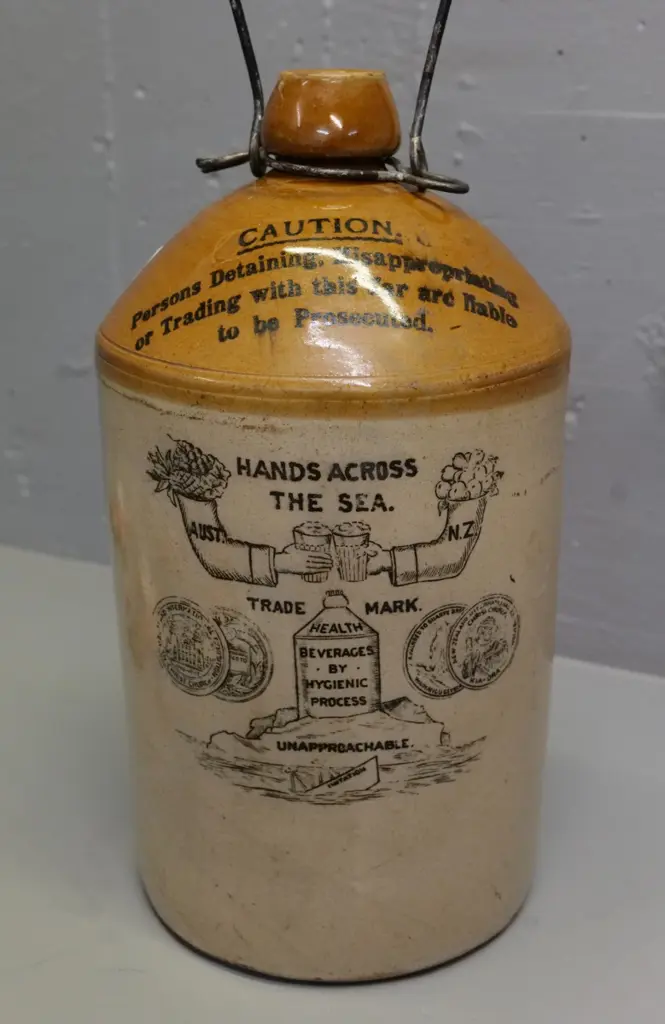 Sharp Brothers NZ & Australia narrow mouth stoneware crock with wire handle, some chips to rim H-360 Image 1++