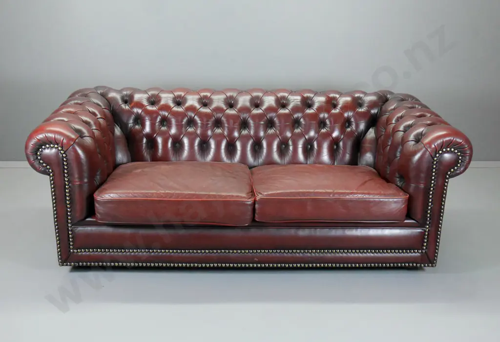 Moran of Melbourne club style rolled arm deep-button burgundy leather 2.5 seater, brass studs, casters H700 W1840 D900 Image 1++