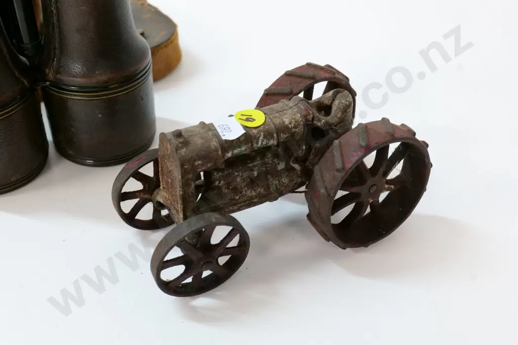 restorer's toy tractor with metal wheels, driver has lost his head, & vintage binoculars in worn leather case Image 1++