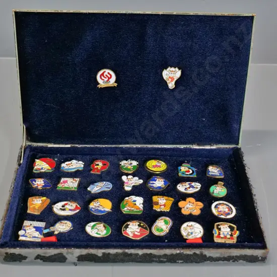 cased collection of 1997 National Games of China enamel badges - paint flaking from metal case