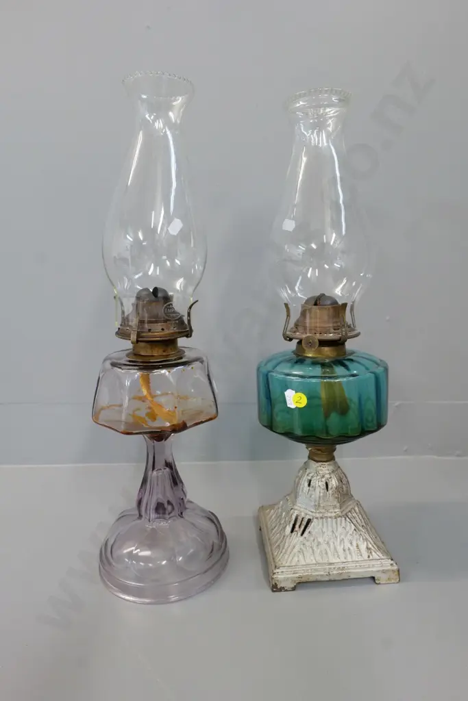 2 vintage kerosene lamps - 1 clear lavender glass and 1 teal glass on metal base, both with chimneys Image 1++