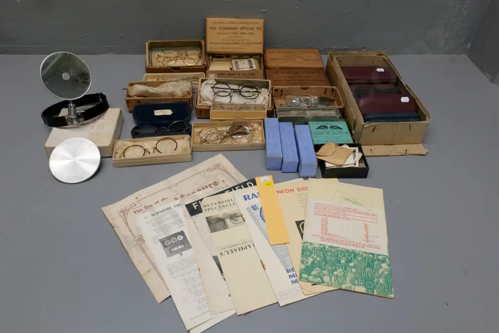 collection of vintage optical items including eyeglass frames and parts, boxed and loose lenses, glass cases, etc. Image 1++