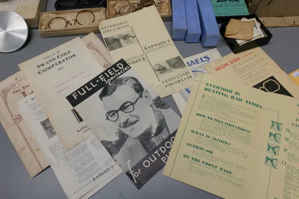 collection of vintage optical items including eyeglass frames and parts, boxed and loose lenses, glass cases, etc. Image 1++