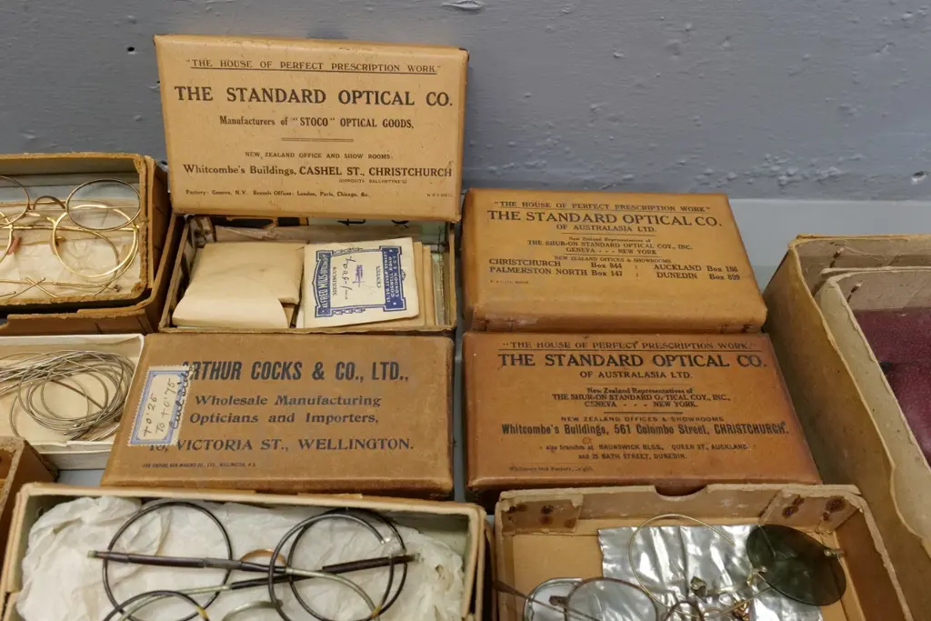 collection of vintage optical items including eyeglass frames and parts, boxed and loose lenses, glass cases, etc. Image 1++