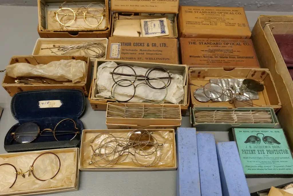 collection of vintage optical items including eyeglass frames and parts, boxed and loose lenses, glass cases, etc. Image 1++
