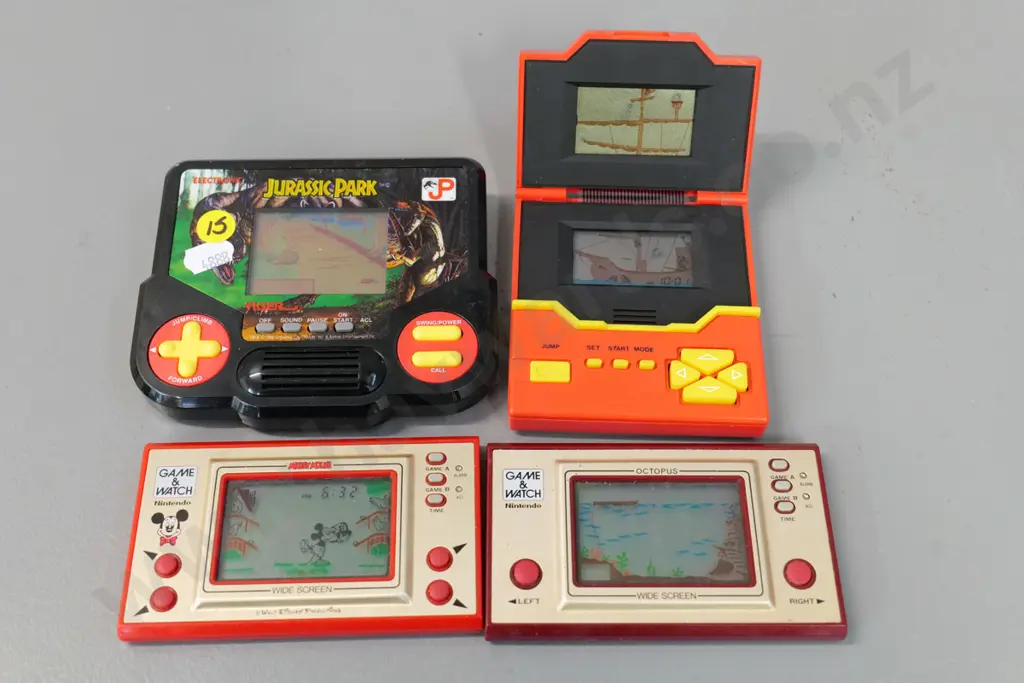 4 retro handheld electronic arcade games - Jurassic Park, Pirates, Nintendo Mickey Mouse & Octopus Image 1++