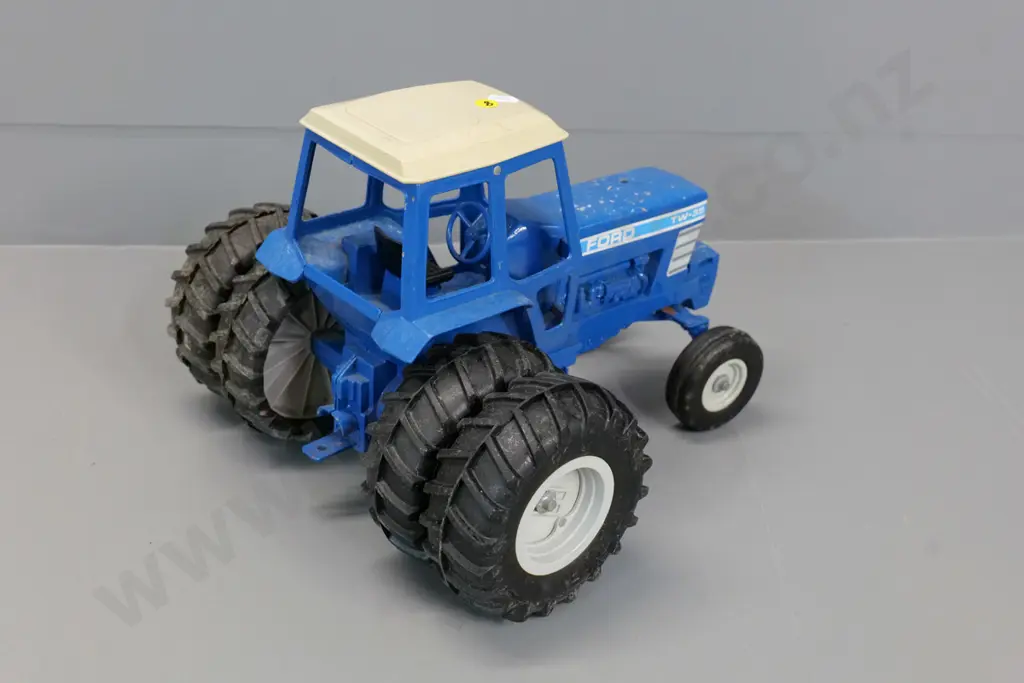 large cast metal and plastic ERTL cast metal Ford TW-35 tractor with working steering - H-260 L-360 W-340 across wheels Image 1++