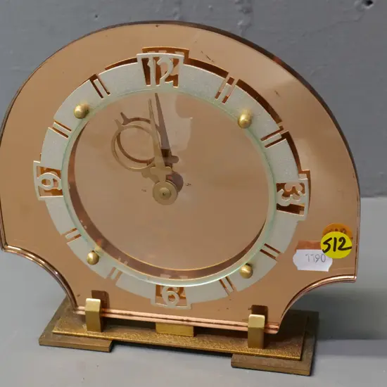 mantel clock with mirrored glass and metal face, marked Made in Britain H-170 W-180