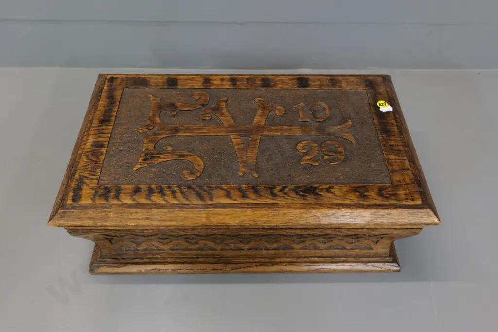 solid oak box with hinged lid, carved motifs and "1929" on lid H-150 W-430 D-260 Image 1++