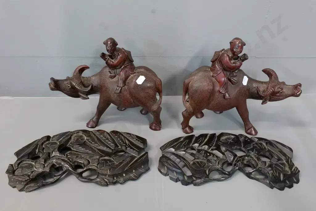pair of composite/plastic figurines H-320 & a pair of carved wood water buffalo on stands, one ear missing Image 1++
