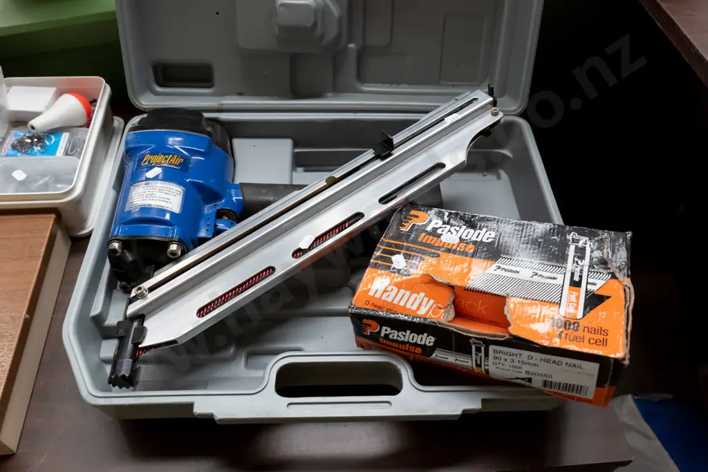 air powered nail gun and box of part nails Image 1++