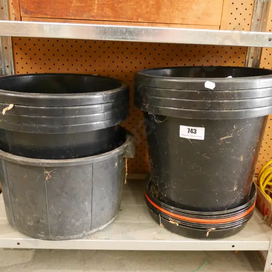 various plastic planters and drip trays