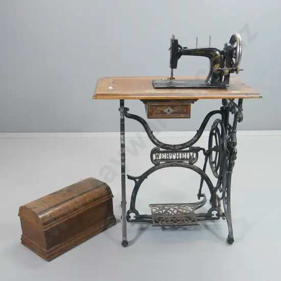 vintage Wertheim sewing machine on cast iron treadle base, timber top, some wear & loss of marquetry H1020 W730 D420