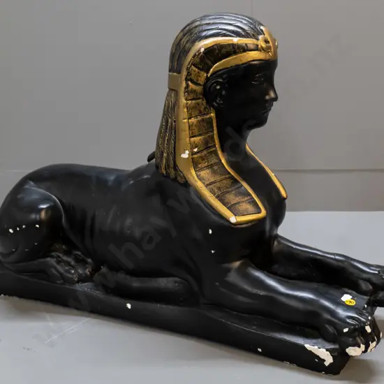 plaster sphinx figure - painted black and gold, areas of paint loss & chips H-460 L-680 W-200