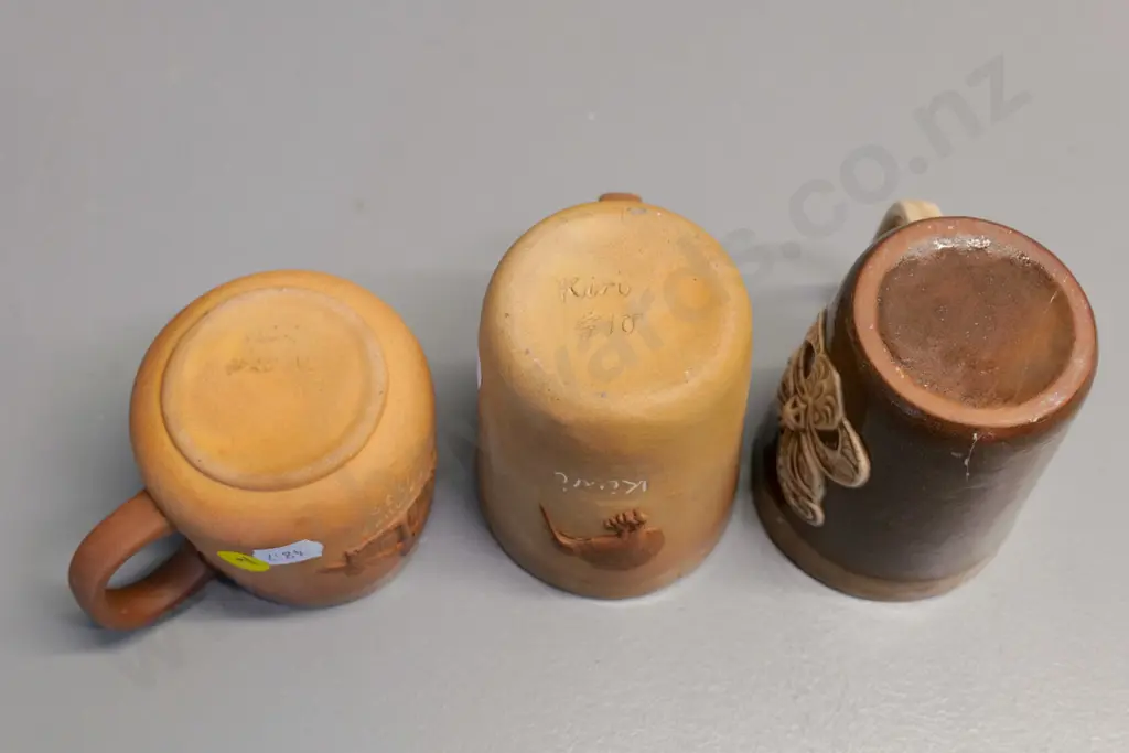 Temuka pottery - 3 Maori motif mugs, smaller w/whare motif dated 1980, each have glaze faults, crack or chip Image 1++