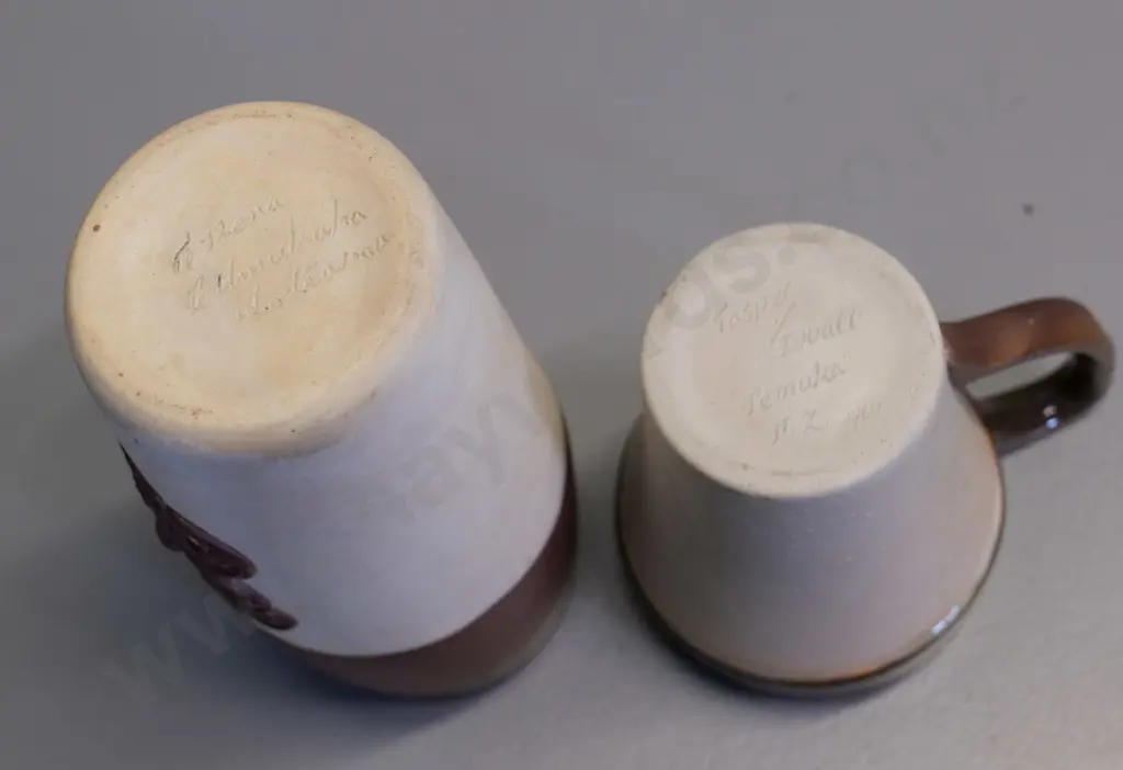 Temuka pottery - 2 cream brown glaze Maori tiki motif mugs, short one marked Jasper Lovatt 1960, has tiny fleck Image 1++