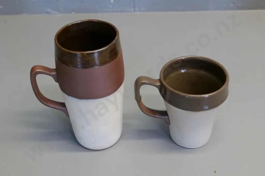 Temuka pottery - 2 cream brown glaze Maori tiki motif mugs, short one marked Jasper Lovatt 1960, has tiny fleck Image 1++