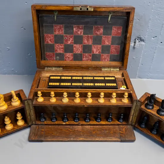 vintage oak-cased games set with fitted interior, hinged opening panels, and game pieces - dominoes, chess, cribbage etc